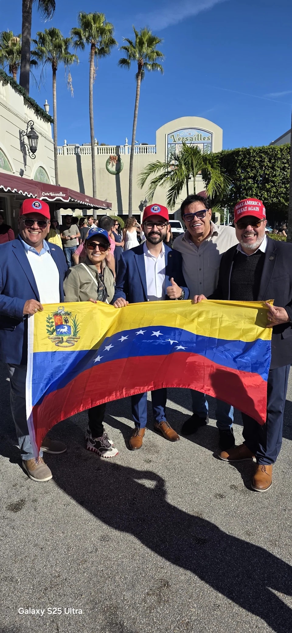 Venezuelan American Gustavo Garagorry, right, celebrated the ouster of Nicolas Maduro outside a popular Cuban restaurant in Miami with friends.