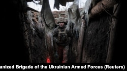 A Ukranian serviceman walks in a trench near Chasiv Yar.