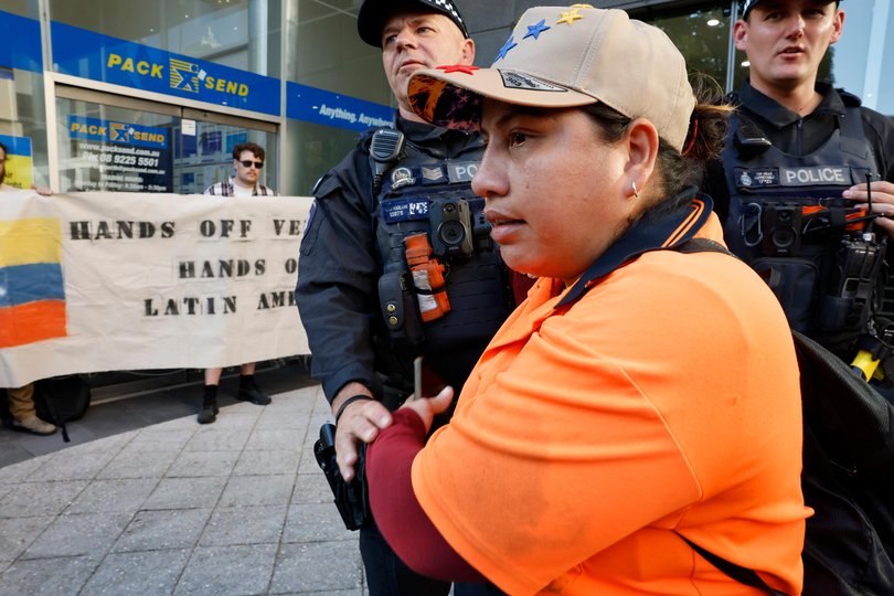 A protester is removed from a gathering outside the US Consulate on St Georges Terrace in the city. Picture: Sandra Jackson