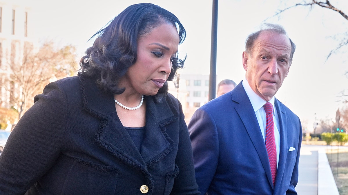 Lisa Cook and Abbe Lowell arrive at the Supreme Court in Washington.