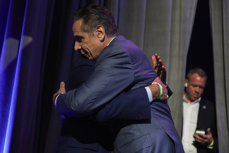Former New York Governor Andrew Cuomo hugs a supporter on election night.