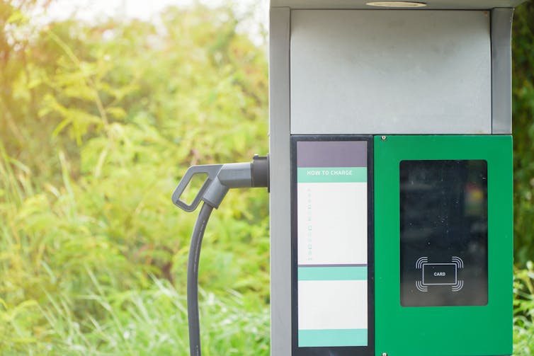 a rural ev charging point with greenery in the background.