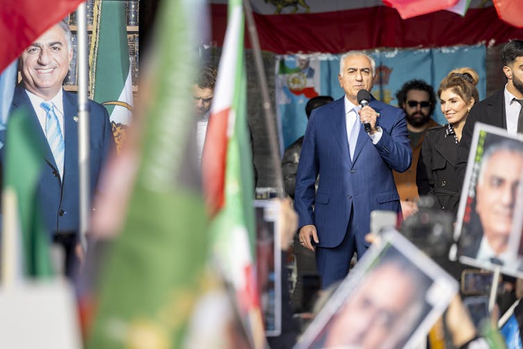 Reza Pahlavi addresses his supporters from a stage.