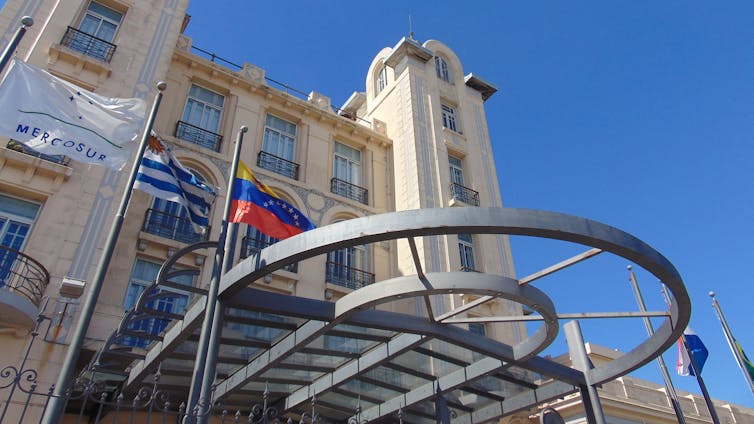 A building with the flags of Mercosur, Uruguay and Venezuela