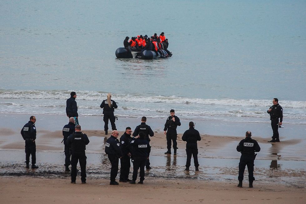 French police watching migrants embark