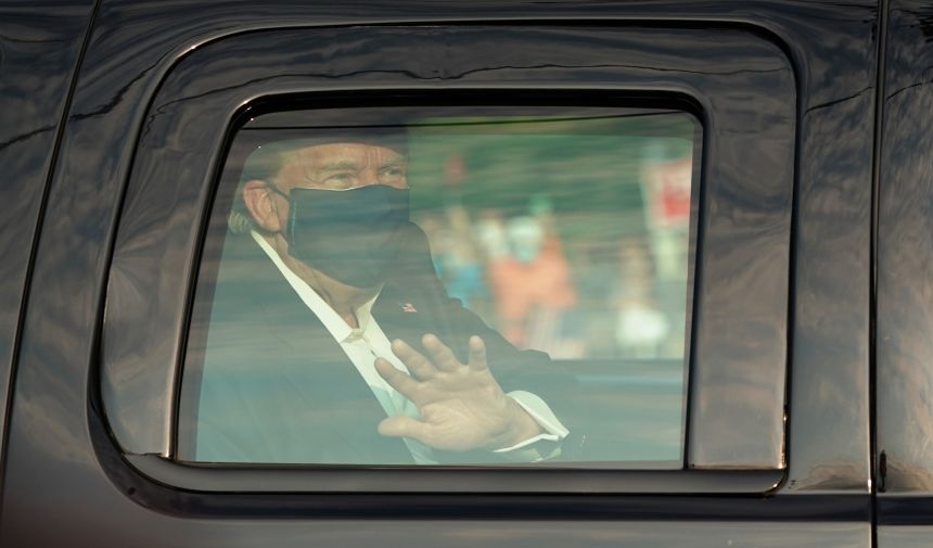 President Trump waves from the back of a car in a motorcade outside of Walter Reed Medical Center in Bethesda, Maryland, on October 4, 2020. Trump was admitted to the hospital after contracting Covid-19.
