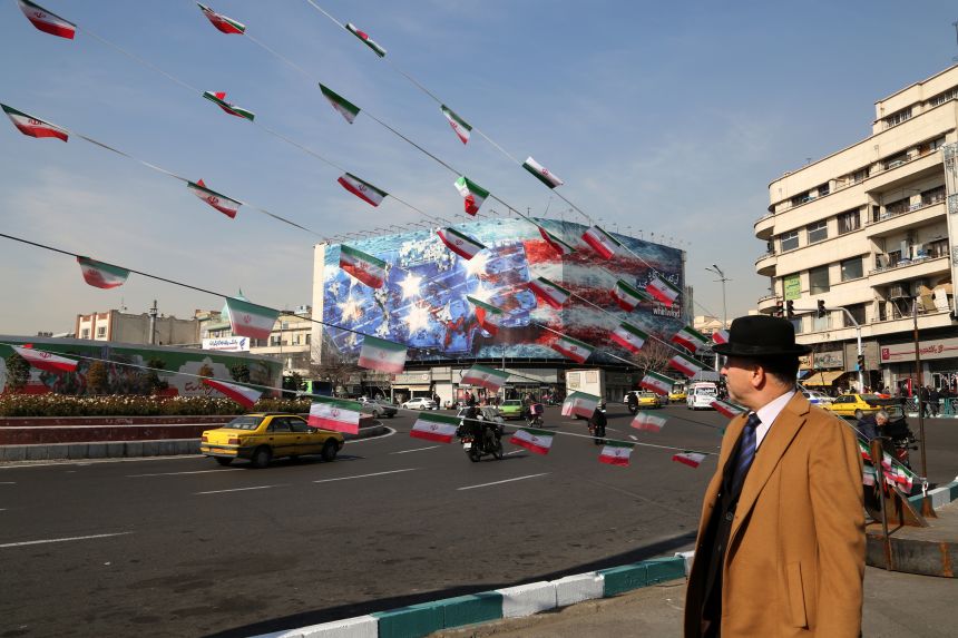 TEHRAN, IRAN - JANUARY 28: A man look at the anti-American posters and Iranian flags displayed following a possible US intervention against Iran on January 28, 2026 in Tehran, Iran. US President Donald Trump on Wednesday urged Iran to make a deal over its nuclear program, or else the next attack would be far worse.
