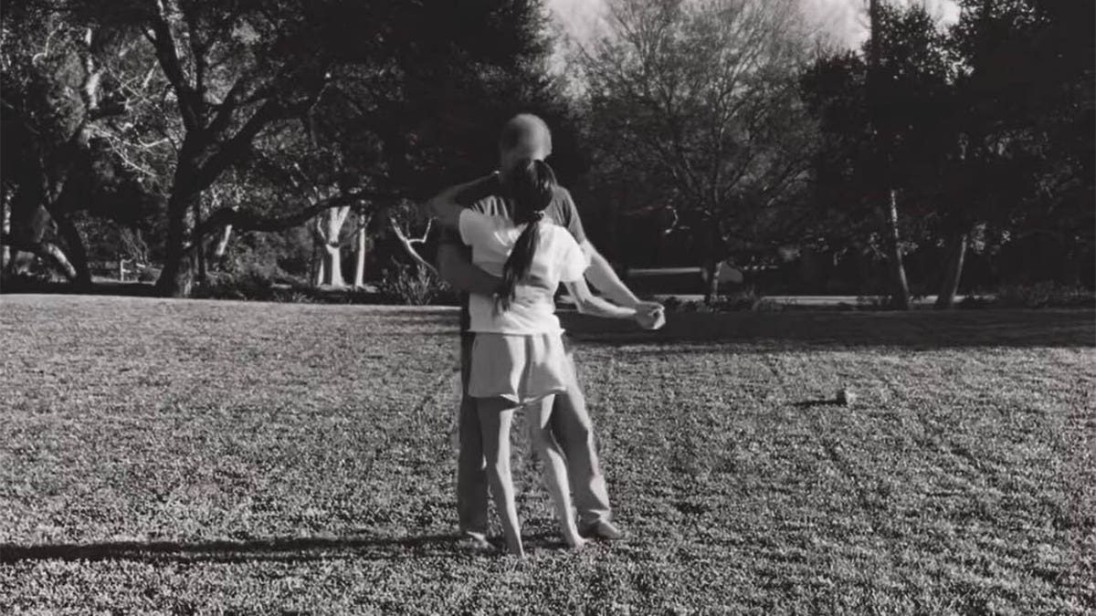 Meghan and Harry dance on a lawn 