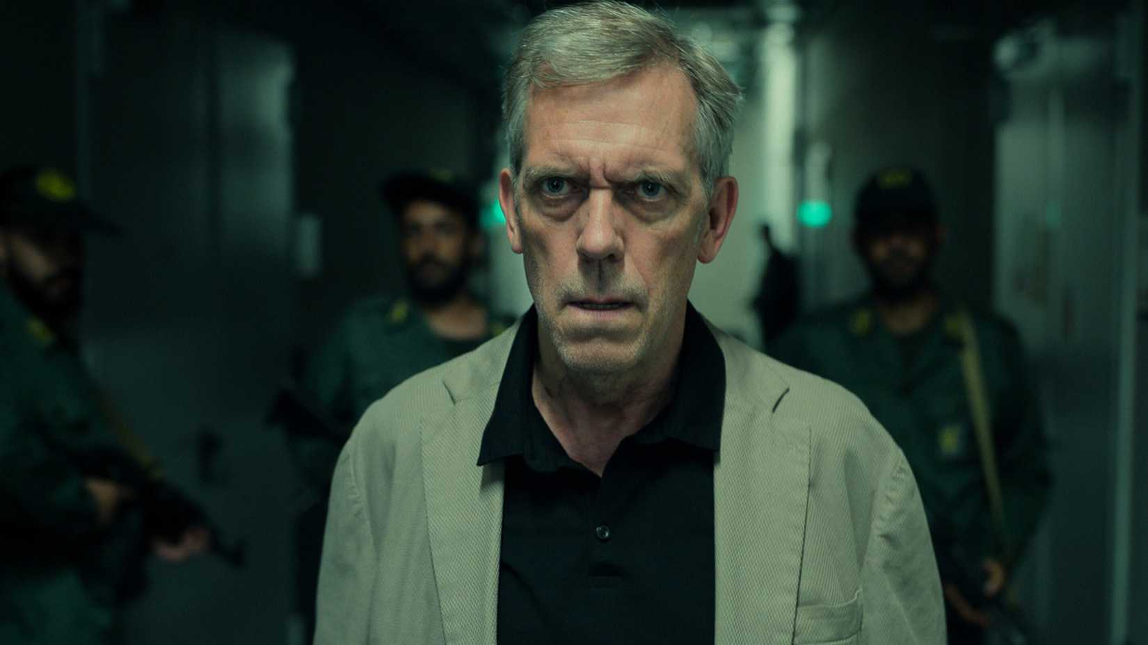 Hugh Laurie looking serious in Tehran