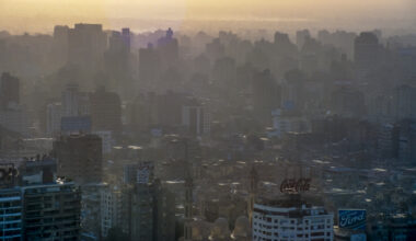 scanned historical colour photo of downtown Cairo with houses in the haze and backlighting