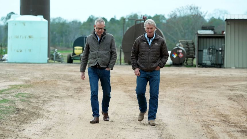 CNN's Jeff Zeleny, left, talks with Franz Rowland on Rowland's farm in Boston, Georgia.