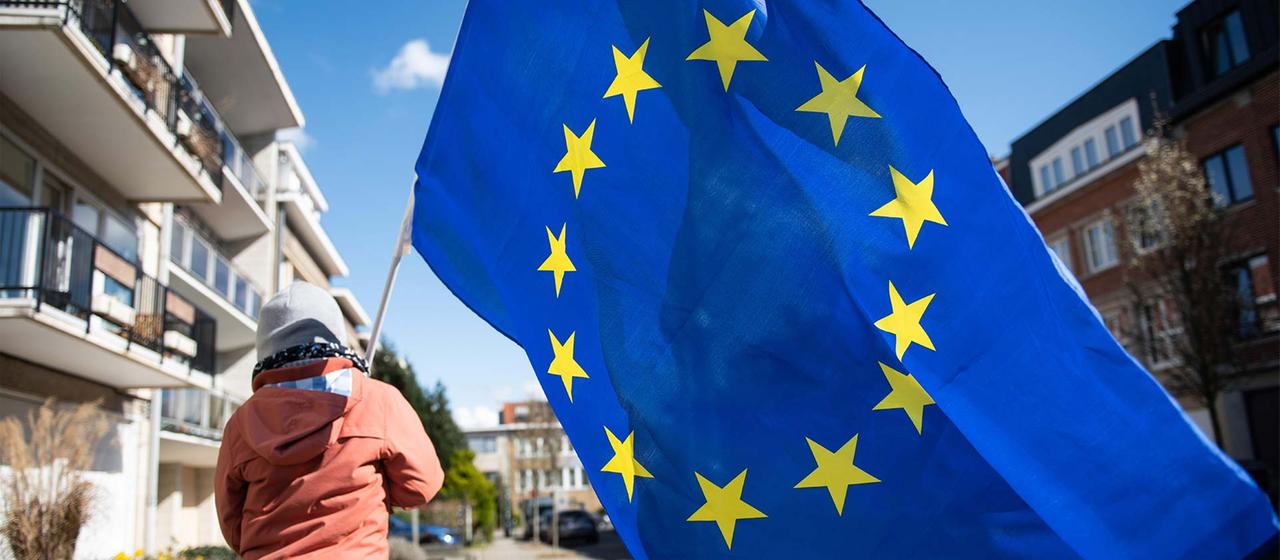 A child with a European flag in Brussels.
