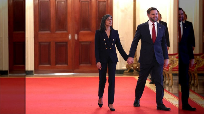 JD Vance and Usha Vance holding hands in the White House