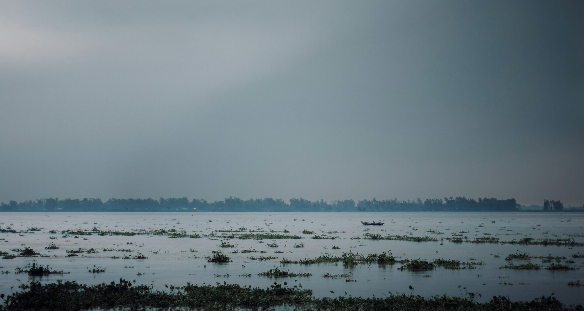 A photo shows dark clouds gathering near Chilmari, Bangladesh, in July 2024 (Kabiur Rahman Riyad/Unsplash)