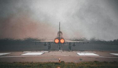 a fighter jet sitting on top of an airport runway