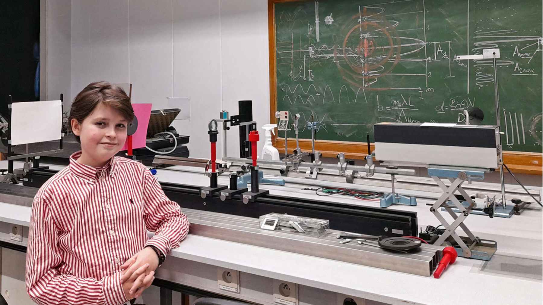 Laurent Simons stands in a physics lab at the University of Antwerp, the teen researcher now pursuing AI-driven medical science to study aging.