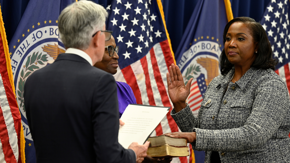 A photo of Federal Reserve Chairman Jerome Powell swearing in Lisa Cook