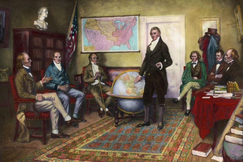 1912 painting by Clyde O. DeLand titled “Birth of the Monroe Doctrine.” From left to right: John Quincy Adams, William Harris Crawford, William Wirt, President James Monroe, John Caldwell Calhoun, Daniel D. Tompkins, and John McLean.