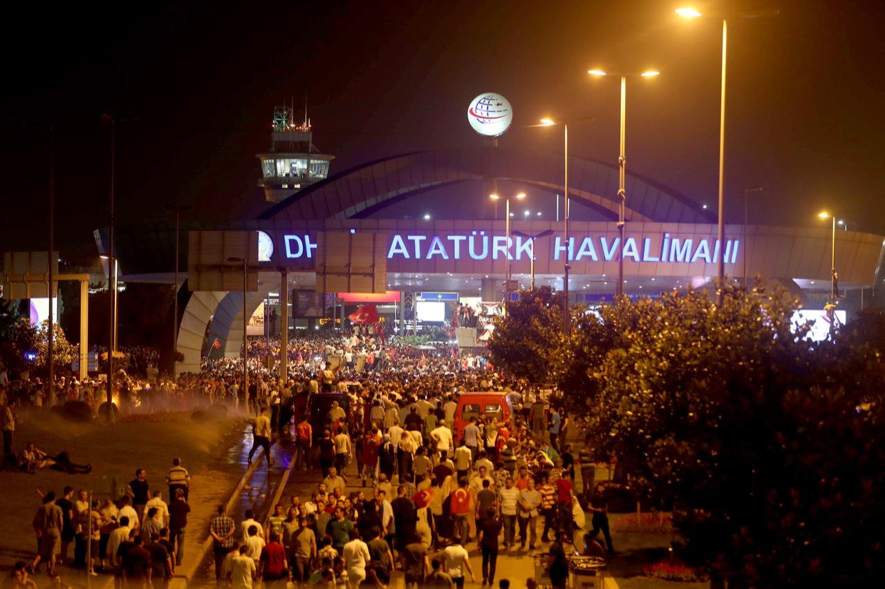 People gather at the Ataturk Airport to react against military coup attempt in Istanbul, Türkiye on July 16, 2016. (AA Photo)