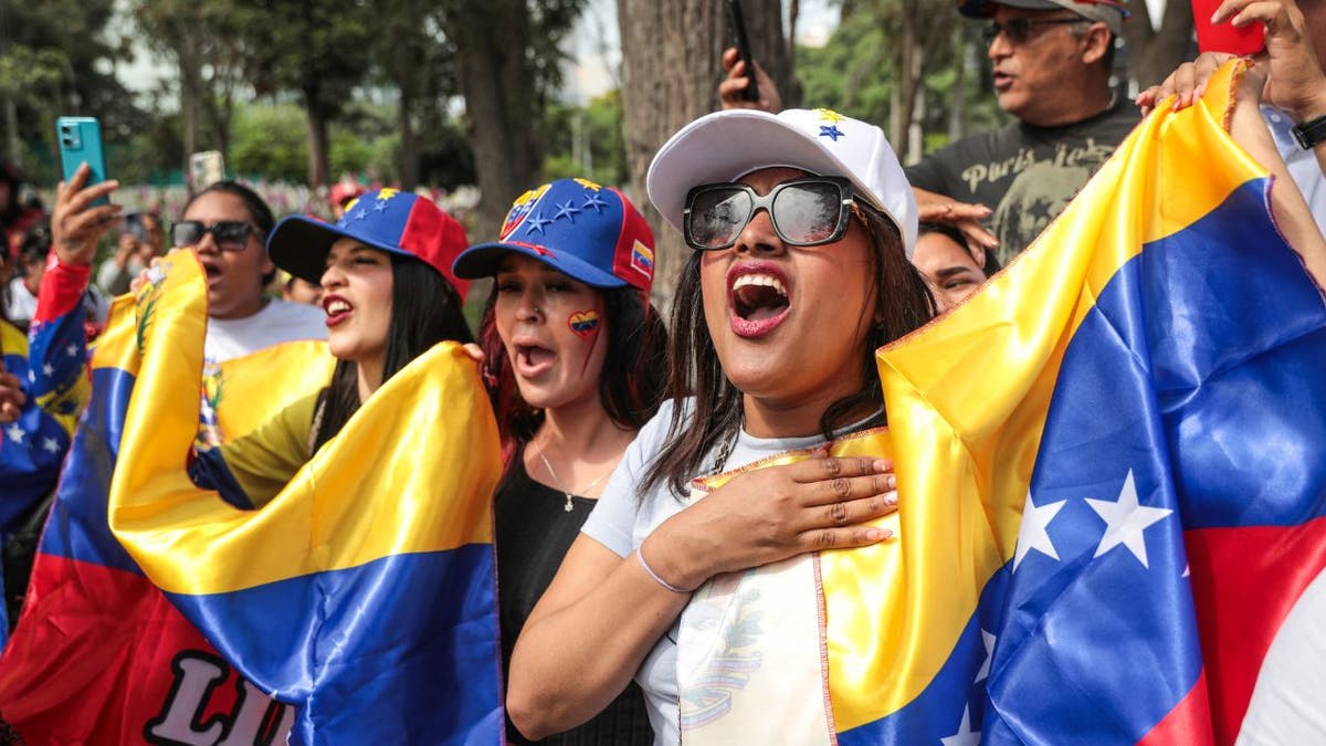 Venezuelans in Peru wave flags and celebrate after news that U.S. forces captured President Nicolás Maduro.