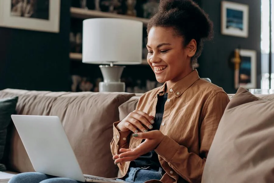 Smiling woman looking at the laptop for online betting