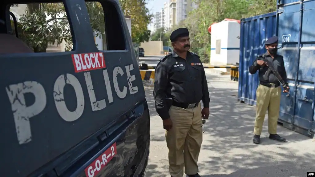 Pakistani police officers stand guard during security operations that have heightened fear among asylum-seeking families and children living in Pakistan. (Photo Credit: AFP)