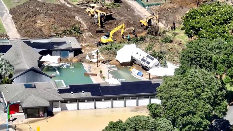 A drone view of diggers working at a campsite damaged by a landslide caused by heavy rains, in Mount Maunganui, New Zealand, January 23, 2026. TVNZ via REUTERS TV/Handout via REUTERS THIS IMAGE HAS BEEN SUPPLIED BY A THIRD PARTY. NEW ZEALAND OUT. NO COMMERCIAL OR EDITORIAL SALES IN NEW ZEALAND. AUSTRALIA OUT. NO COMMERCIAL OR EDITORIAL SALES IN AUSTRALIA. No use New Zealand internet sites/any internet site of any New Zealand or Australia based media organisations or mobile platforms.