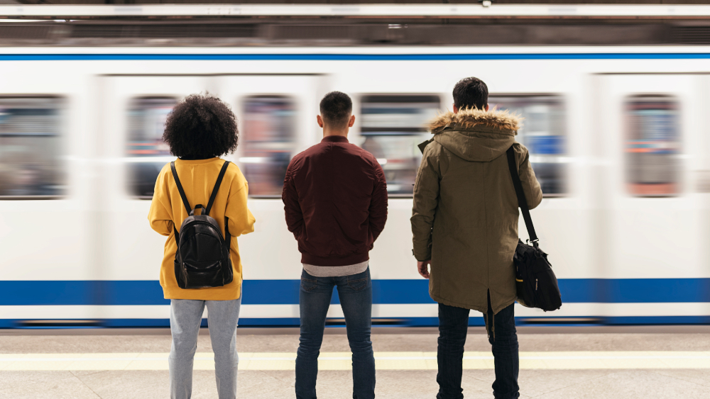 People waiting in front of a passing train.