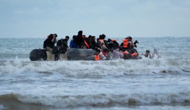 People thought to be migrants wade to board a small boat in France. Pic: PA