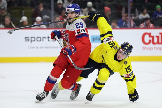 Sweden Ivar Stenberg (15) hits Czechia forward Samuel Drancak (29) in the face with his stick during the first period of an IIHF World Junior Hockey Championship gold medal game, Monday, Jan. 5, 2026, in St. Paul, Minn. (AP Photo/Matt Krohn)