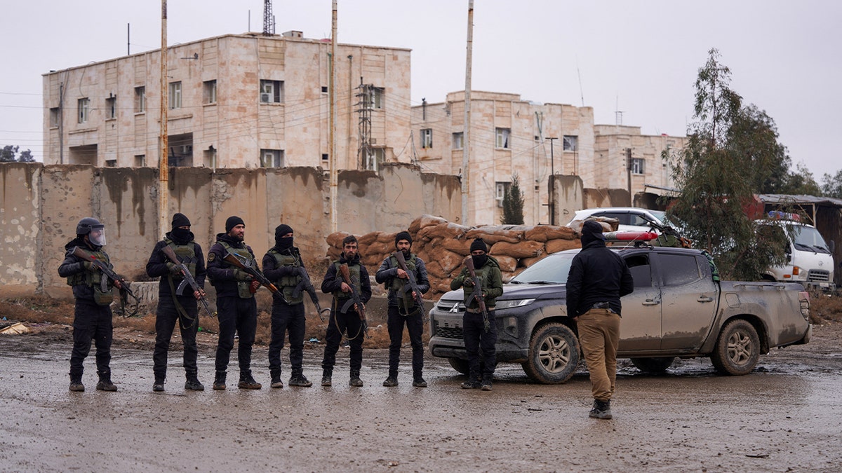 Syrian security forces stand guard outside al-Aqtan prison, where some Islamic State detainees are held, in Raqqa, Syria January 23, 2026.