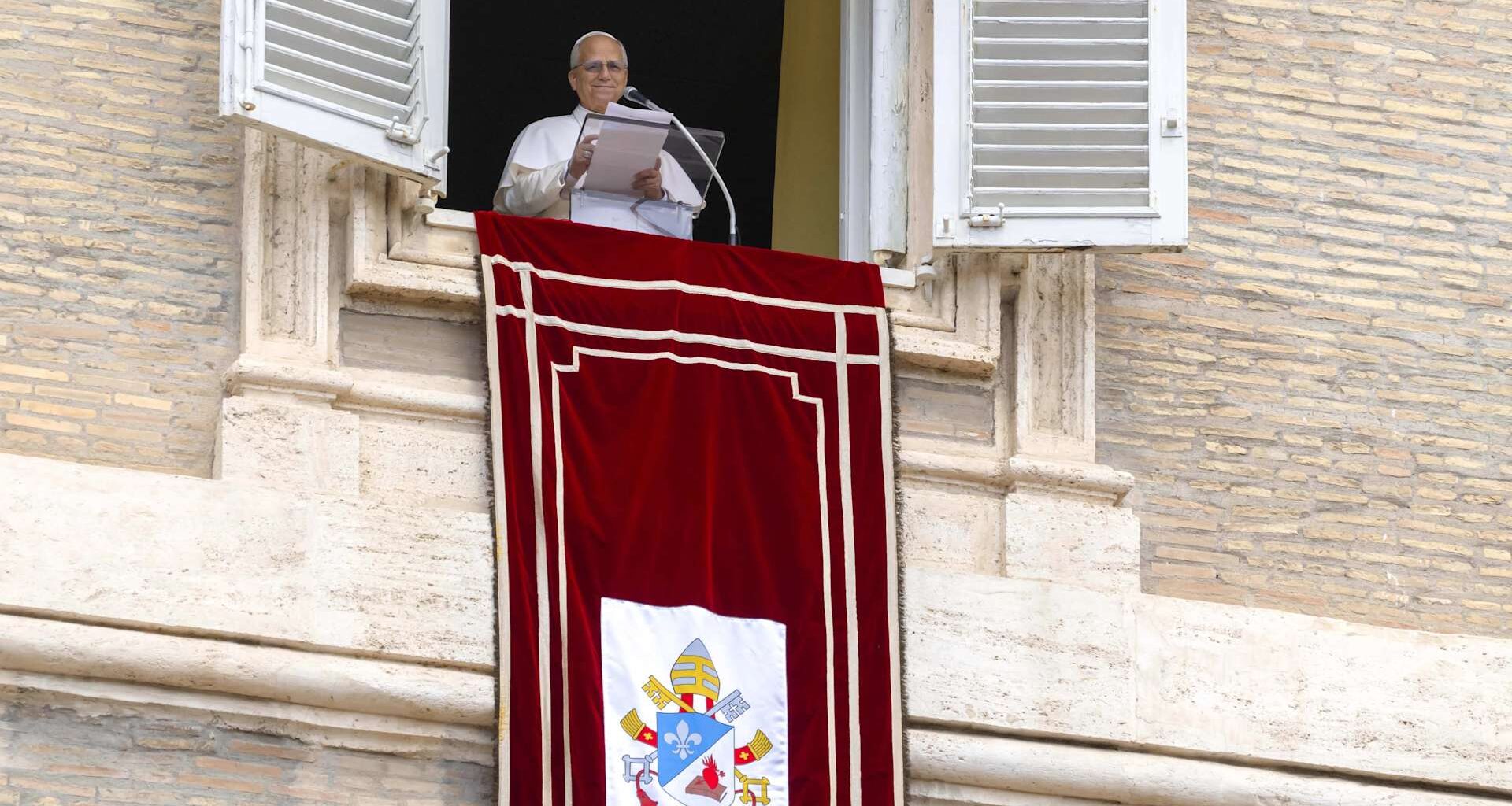 Pope Leo XIV speaks from a window of the Apostolic Palace overlooking St. Peter’s Square during the Sunday Angelus on Aug. 24, 2025.