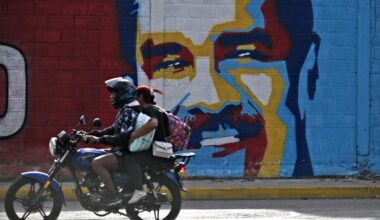 A motorcycle rides past a graffiti depicting Venezuelan President Nicolas Maduro in Caracas on Dec. 3, 2026. (AFP Photo)