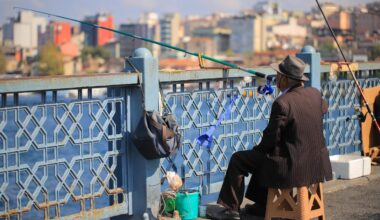 An old man catching a fish on a bridge, Istanbul, Türkiye. (Adobe Stock Photo)