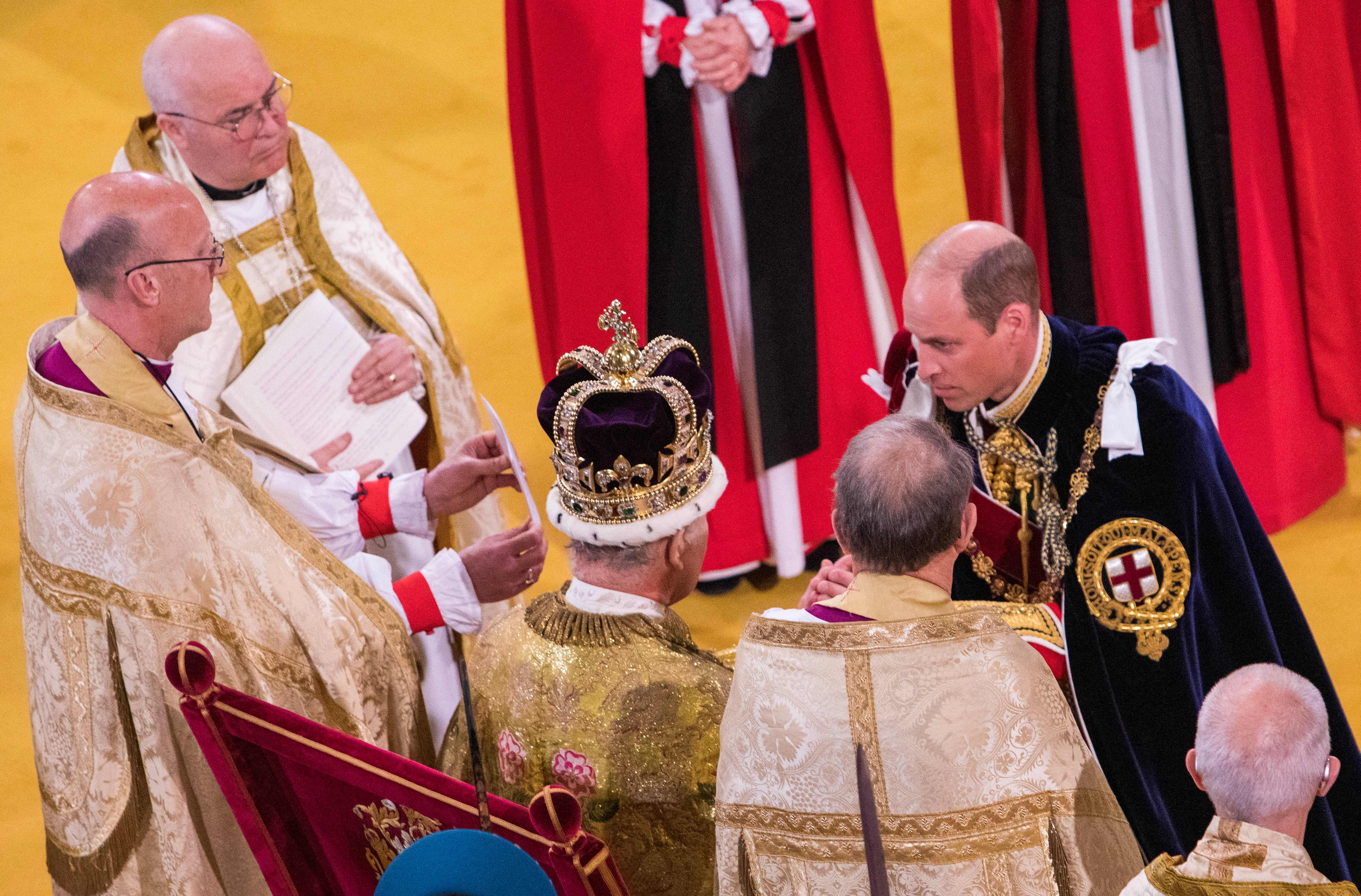 Prince William kneeling down in front of King Charles at his coronation