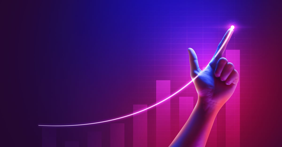 A hand pointing at a chart line going up.