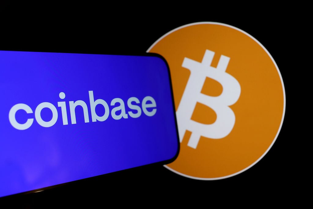 A phone displaying the Coinbase logo next to Bitcoin.
