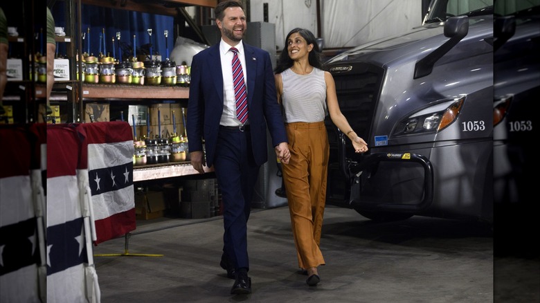 Usha Vance gazes at JD Vance with a smile as they walk hand in hand