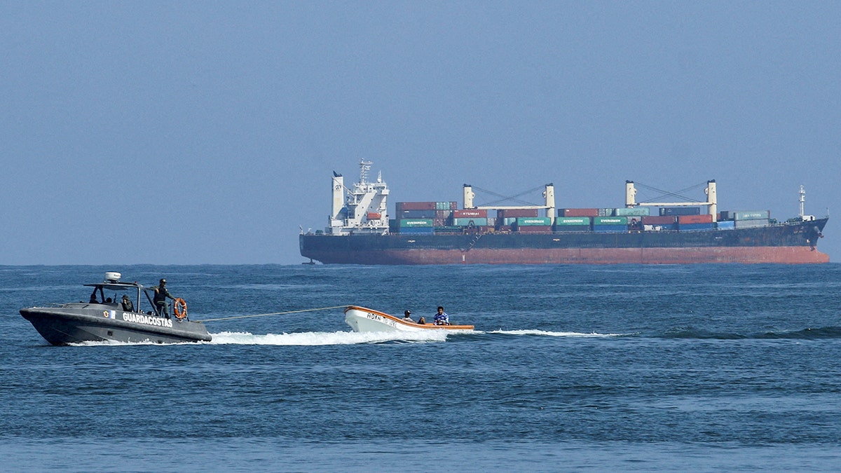 Venezuelan Navy boat operates off coastline.