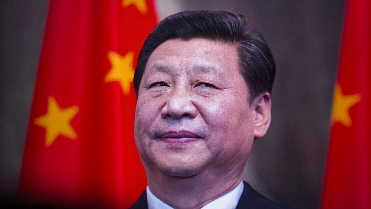 Xi Jinping in front of a Chinese flag.