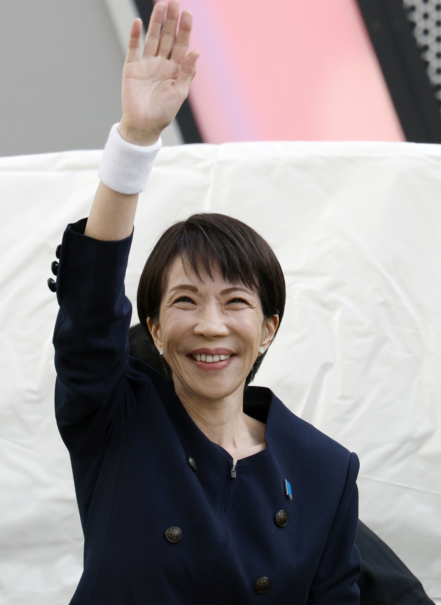 Japanese Prime Minister Sanae Takaichi waves to an election campaign rally.