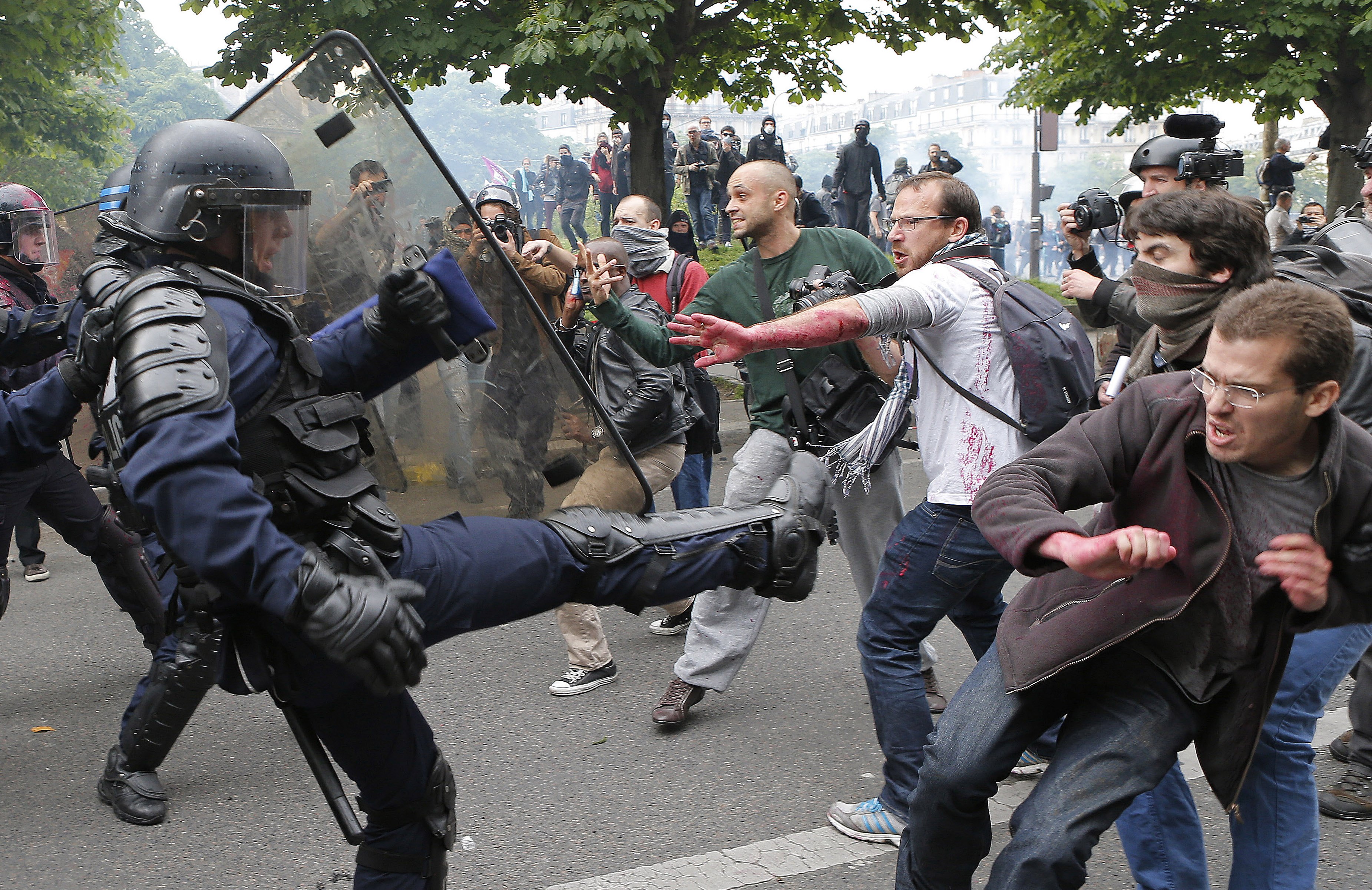 Riot police officers clash with protestors during a demonstration in Paris, France.