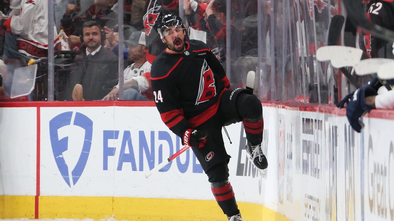 A men's hockey player celebrates a goal.