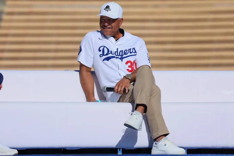 Dodgers manager Dave Roberts sits on stage during Dodgerfest at Dodger Stadium on Saturday.