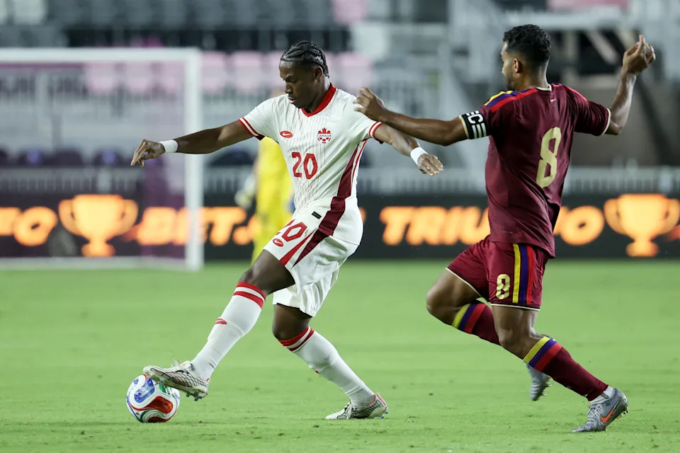 FORT LAUDERDALE, FLORIDA - NOVEMBER 18: Jonathan David #20 of Canada and Cristian Casseres Jr. #8 of Venezuela compete for the ball during the International Friendly match between Venezuela and Canada at Chase Stadium on November 18, 2025 in Fort Lauderdale, Florida. (Photo by Leonardo Fernandez/Getty Images)