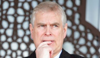 Prince Andrew wearing a black coat and looking anxious