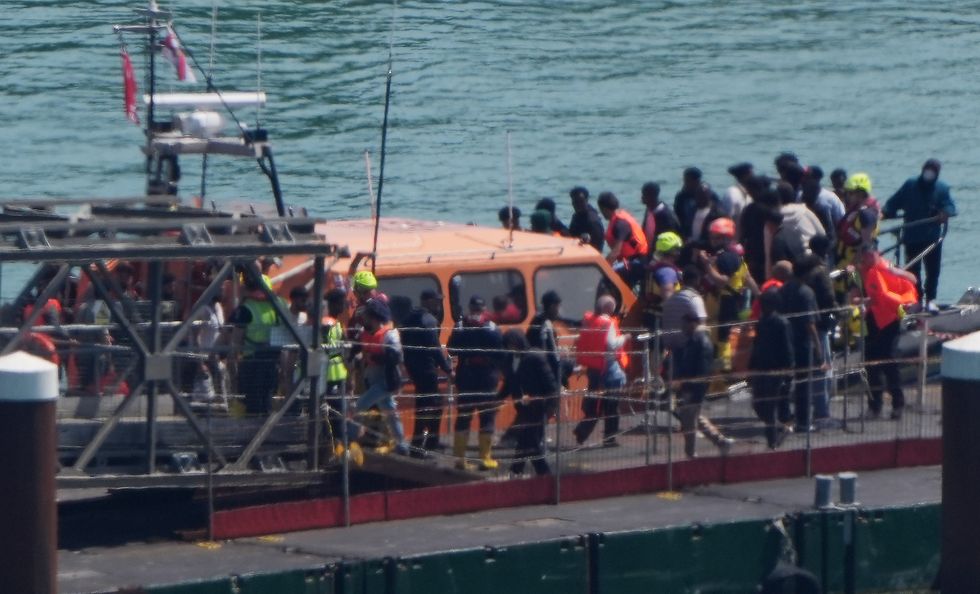 A group of people thought to be migrants are brought in to Dover, Kent