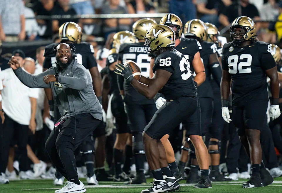 Vanderbilt defensive line coach Larry Black and Vanderbilt defensive lineman Khordae Sydnor (96) celebrate Sydnor's second-half fumble recovery during their game at FirstBank Stadium in Nashville, Tenn., Saturday, Aug. 30, 2025.