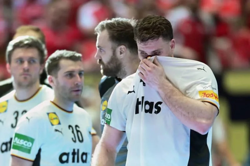 Germany's Johannes Golla (R) reacts after the European Men's Handball Championship final match between Germany and Denmark at the Jyske Bank Boxing. Sina Schuldt/dpa