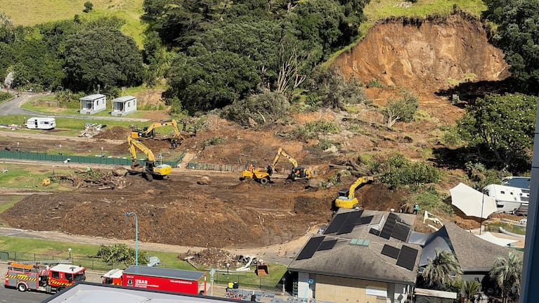 Diggers work at the site of the Mount Maunganui landslip.